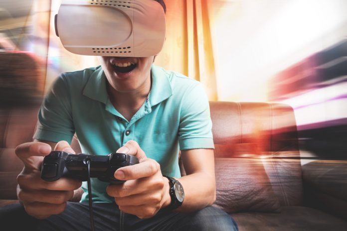 Man wearing virtual reality goggles watching movies or playing v