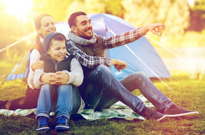 happy family with tent at camp site