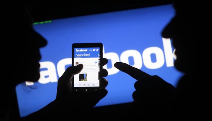File of a smartphone user showing the Facebook application on his phone in Zenica